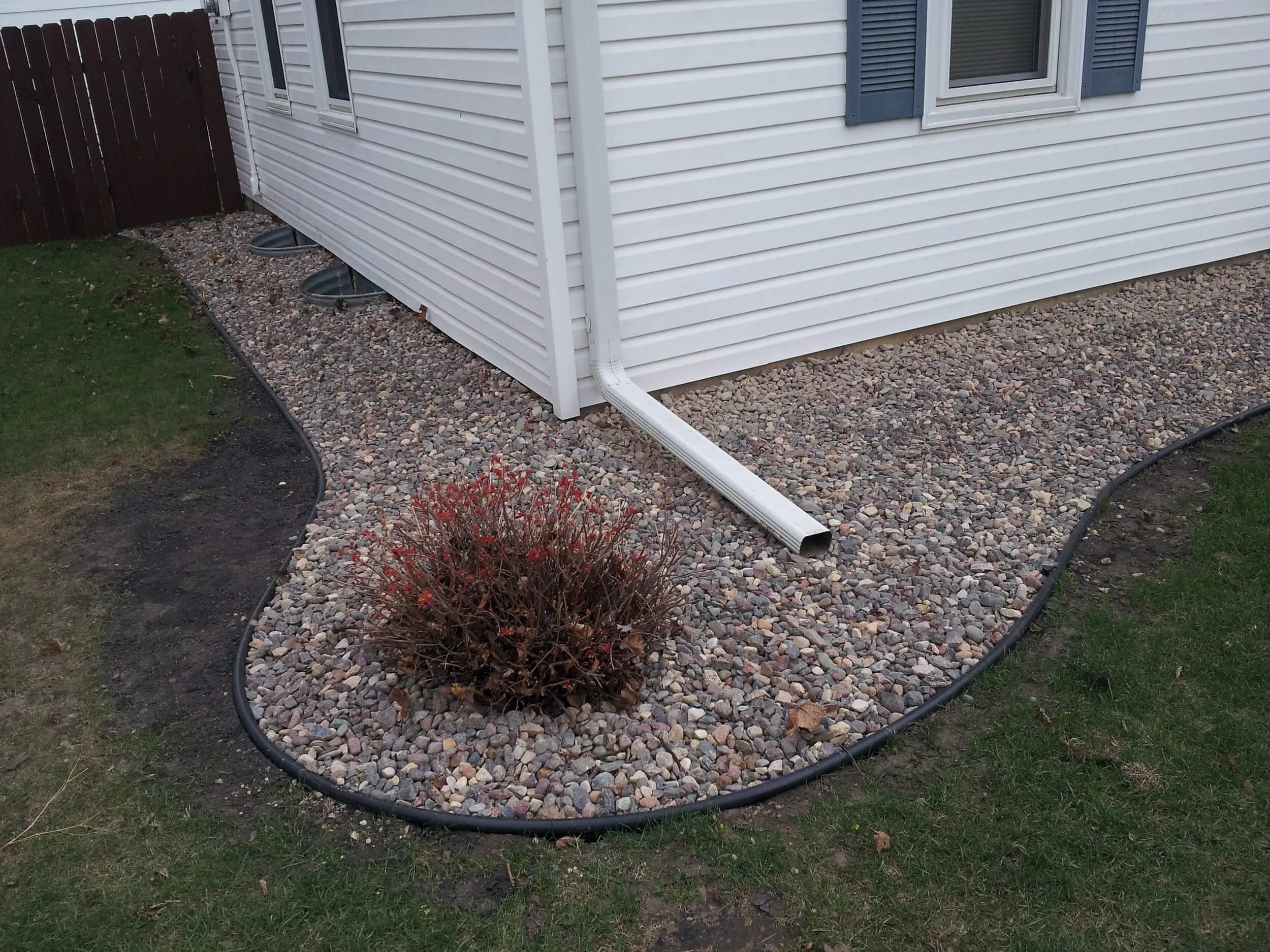 Corrective grading and landscaping around home foundation